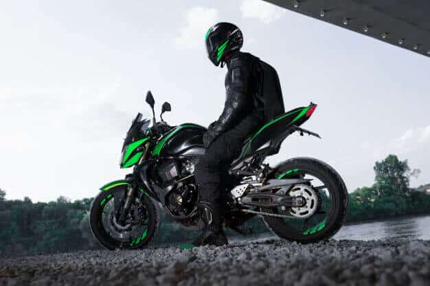 motorcyclist-stop-bridge-road-waiting-rain