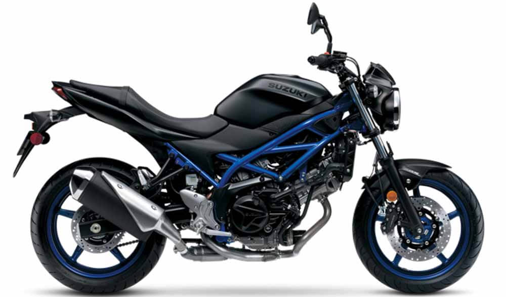 The 2023 SV650 ABS in a stunning Metallic Reflective Blue, featuring a striking bodywork that is beautifully enhanced by a dark-gold metallic coating on the frame and wheels, making it distinct from its 2022 counterpart, the Metallic Matte Black Suzuki SV650 ABS.