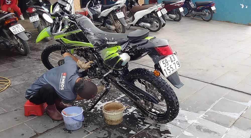 Leaning over to reach difficult-to-reach areas of the motorcycle. Bikes are delicate machines with intricate details that require some tender love and care to keep running correctly. Be gentle, but thorough, when cleaning the underside.