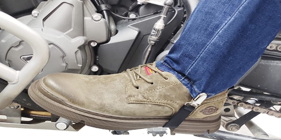 A black boot wrap securely loops around the shaft of a brown motorcycle boot