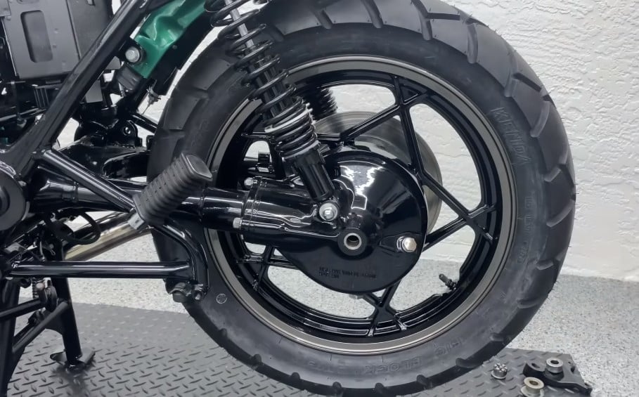 A closeup of the foldable aftermarket footpegs to be shared between the rider and any stowaway pillion. Clip-on handlebars and rear set footpegs bring cafe-racers closer to their flashy sport bike dream and to off-road riders unfathomable pain.